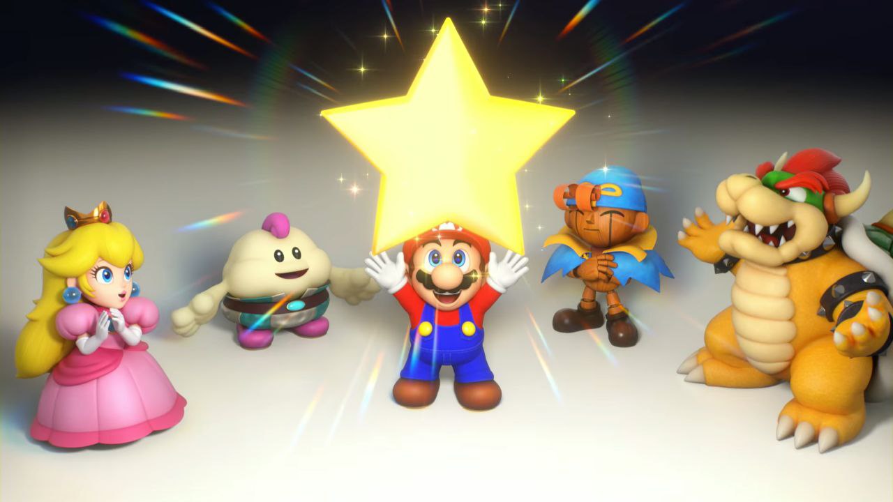 Los protas con MArio en el centro y el resto rodeandole con las manos arriba a lo genkidama pero en vez de una bola enorme de energía, hay una estrella amarilla